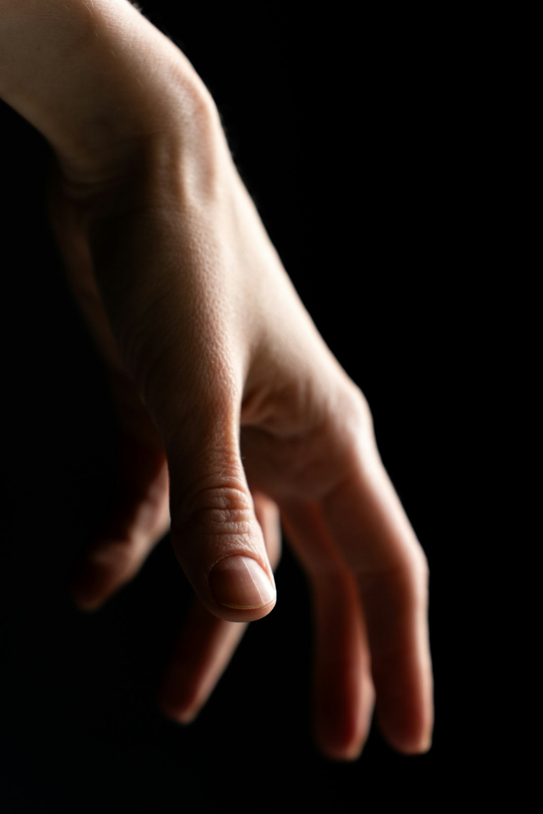 a close up of a person's hand reaching for something