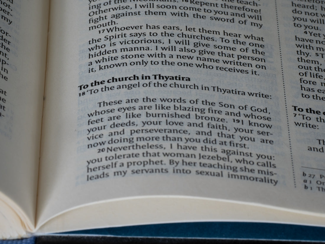 Open bible shows a passage about the church in thyatira.
