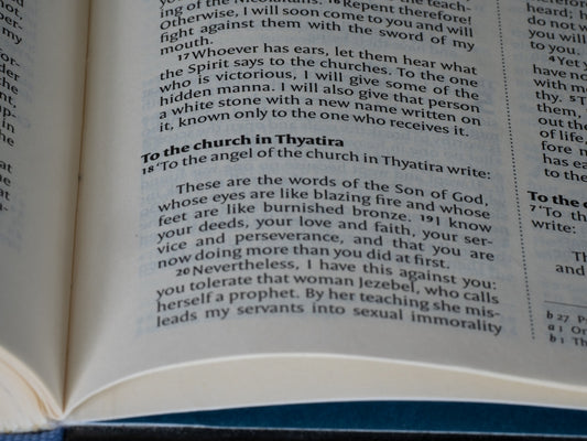 Open bible shows a passage about the church in thyatira.